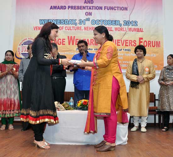 Amruta receiving Sangeet Ratna Award